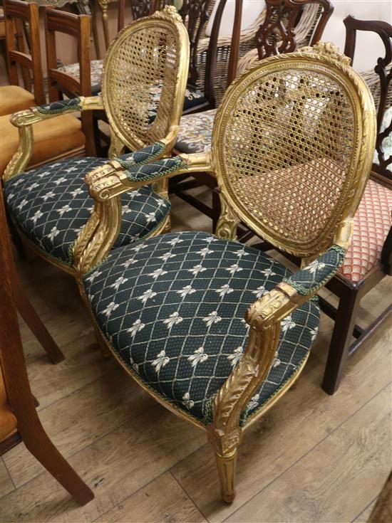 A pair of Louis XV style carved giltwood caned back fauteuils